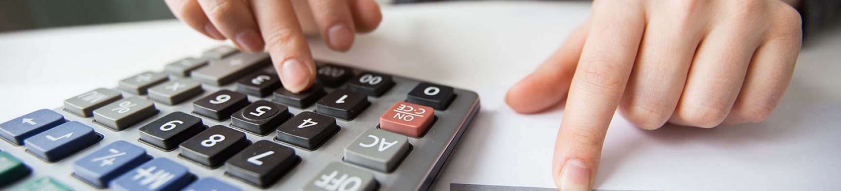 closeup-accountant-hands-counting-calculator